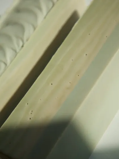 The smooth bottom of the 'Minty Breeze' loaf, showing the subtle swirls of natural colorants.