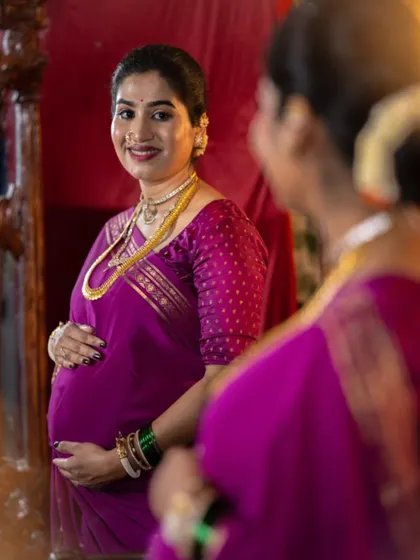A beautiful moment of reflection. For this traditional baby shower look, I used warm, glowing makeup to complement her magenta silk saree and gold jewelry.