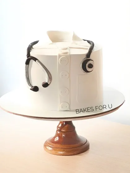 "Congratulations Dr. Aditya." A simple and elegant cake designed to look like a doctor's coat with a stethoscope. A perfect way to celebrate a medical school graduation or achievement.