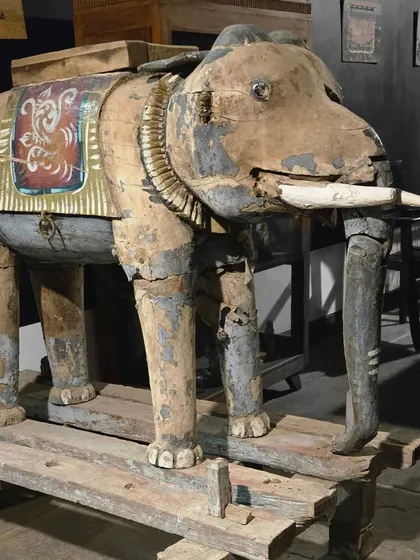 This antique wooden elephant sculpture is a treasure of Indian folk art. Its weathered surface and traditional carvings are a testament to the rich cultural heritage and craftsmanship of past eras.