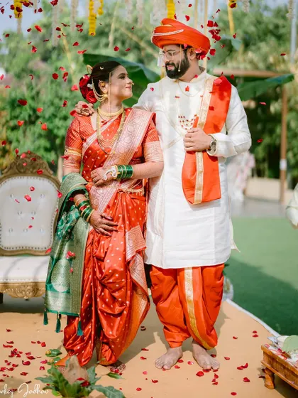 The couple standing together after the rituals, showered in petals.