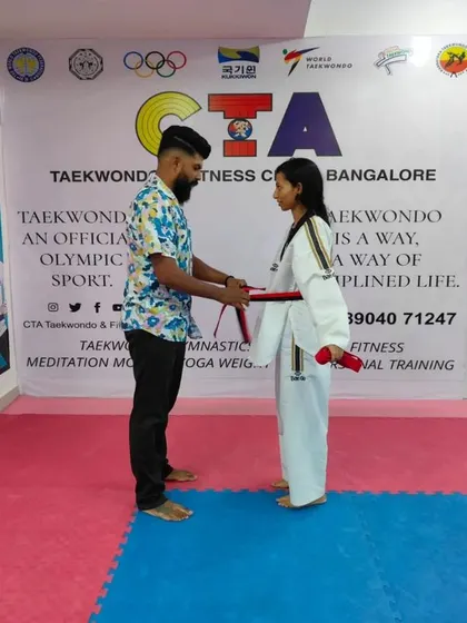 Tying a red belt.