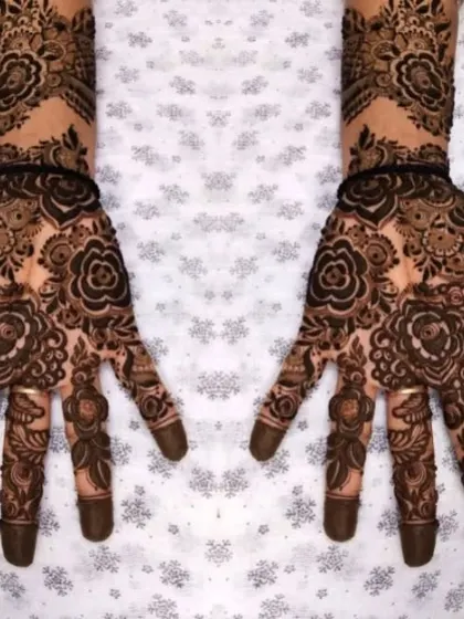 A mirrored image showing the symmetry and beauty of a floral-themed bridal henna. The design is dense and rich, perfect for a grand celebration.