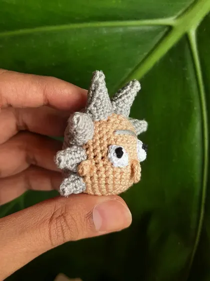 A side view of the Rick amigurumi shows the spiky hair detail from another angle. Each spike is individually crocheted and attached.