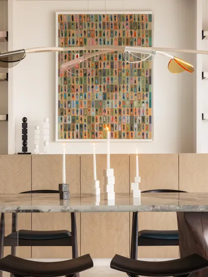 The dining table, with its acrylic leaf light fixture dancing overhead, is a perfect example of the whimsical and creative spirit of this family home.