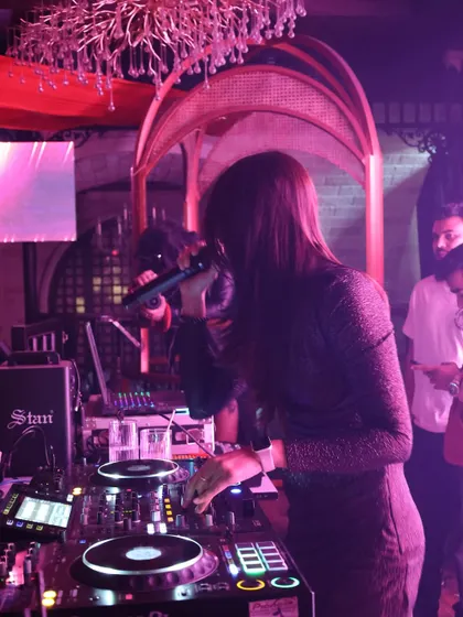 On the mic at Romeo Lane, getting the crowd hyped. Vocal interaction is a key part of my performance style, making the night more engaging.