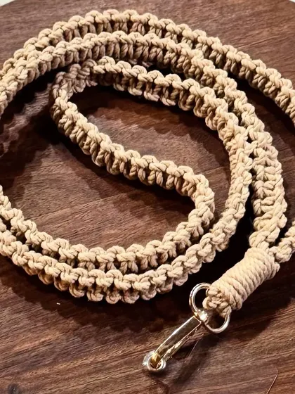 A simple yet elegant mobile lanyard in a natural beige color. It's a sustainable and stylish way to carry your phone.