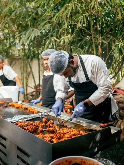 Our chefs in action at a live cooking station during an outdoor event. This adds an interactive and engaging element to corporate parties or private celebrations.