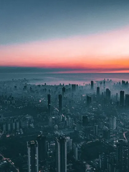 A wide aerial shot of Mumbai, with a dramatic edit that casts the entire city in a dark, moody, and cinematic light.