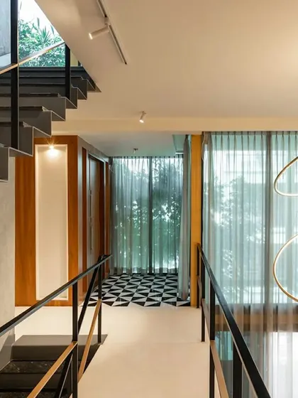 The bridge on an upper level of 'SOL' connects two private zones. The design uses a bold checkered floor pattern as a visual accent, demonstrating how we introduce surprising details to animate circulation spaces.
