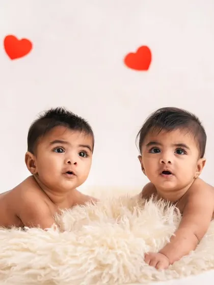Tummy time is twice as cute with twins! These brothers are lying side-by-side on a soft rug during their half-birthday milestone session.