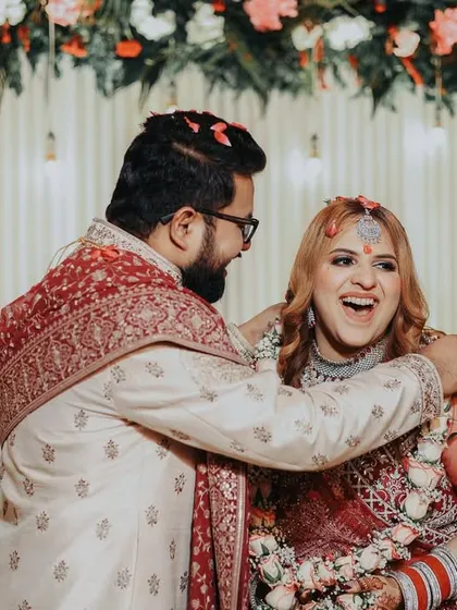 A beautiful, happy moment between the couple, showered with flower petals. These are the joyful memories that make a wedding album special.