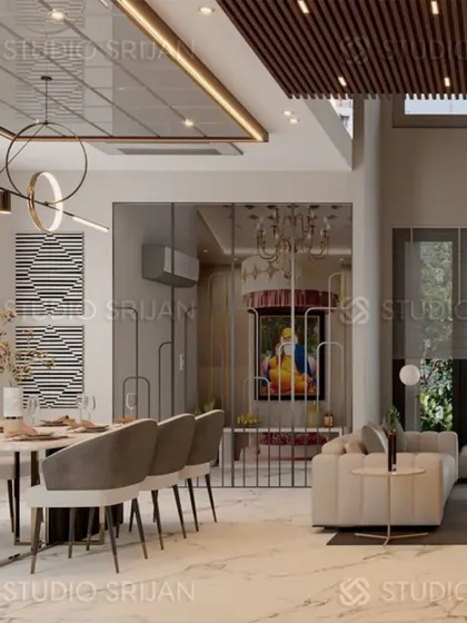 This open-plan space in Model Town includes a dining area, a living room, and a beautifully integrated glass-enclosed mandir.
