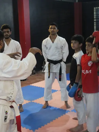 An instructor gives guidance to students before their kumite test. Proper instruction and correction are key parts of the grading process.