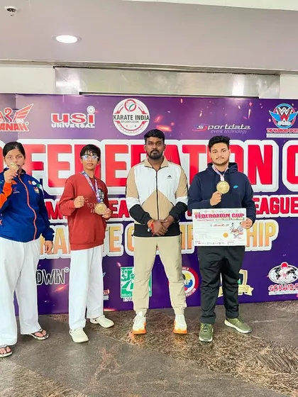 Standing with my medal-winning students at the KIO Federation Cup. My focus is on preparing each athlete to reach their highest potential.