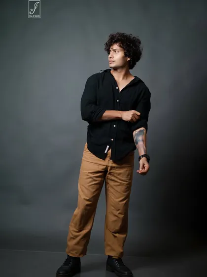 This shot highlights the model's arm tattoo and captures a candid, off-camera glance, adding personality to the series.