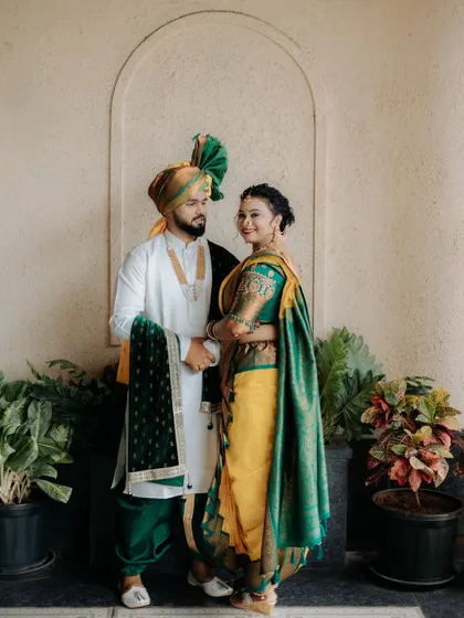 A classic couple portrait showing the beautiful coordination of the bride and groom's green and yellow traditional outfits.