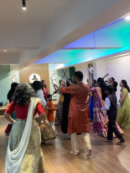 Participants learning dandiya steps during a workshop. My instruction is clear and patient, ensuring everyone can master the basics and have fun.