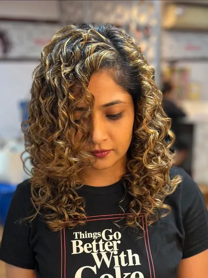 A close-up of the hand-painted blonde curls.