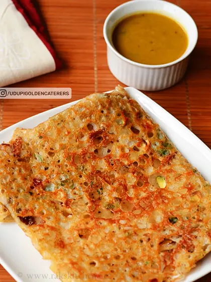 Our crispy Rava Dosa, made from semolina batter and folded neatly. It is served with a side of flavorful sambar, a popular choice for breakfast and tiffin services.