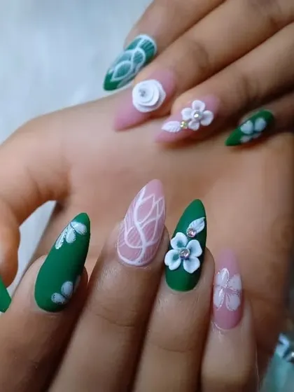 A garden of artistry on your fingertips. This set features a matte green base with hand-painted white florals, paired with a soft pink base, abstract line work, and intricate 3D flower sculptures.