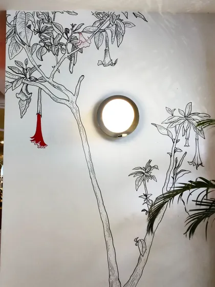 We integrated this floral doodle around an existing wall lamp, making the light fixture a part of the artwork itself.