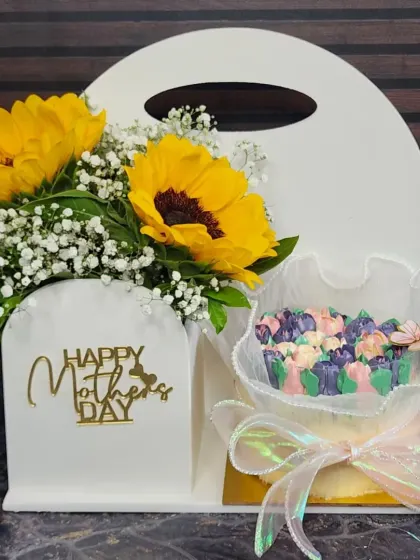 A complete Mother's Day gift set. This hamper includes a fresh sunflower arrangement alongside a mini edible bouquet cake, combining the beauty of real flowers with a delicious treat.