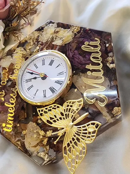 A full view of the custom hexagonal clock, showing how it can be a beautiful decor piece for a living room or side table. The preserved flowers and gold details make it truly unique.