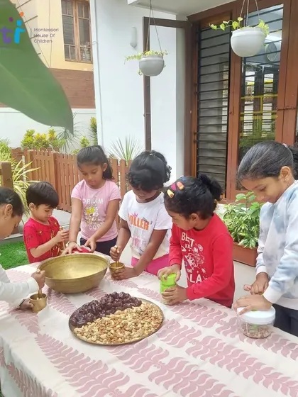 Older children take the lead in preparing the ingredients for the modaks, grinding nuts and chopping dates. This teaches responsibility and allows them to act as role models.