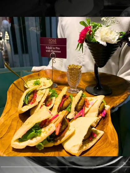 Another angle of our Falafel in Pita with Hummus, showcasing the fresh ingredients and elegant presentation. We customize our menus to fit any party theme.