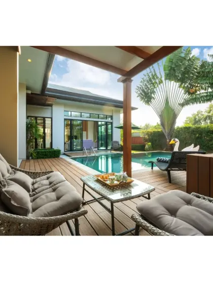 Imagine relaxing here. This poolside deck is made from Wood Plastic Composite (WPC), a fantastic material that gives you the look of wood without the constant maintenance. Paired with tropical plants like the Traveller's Palm, it creates a perfect, low-fuss luxury retreat right in your backyard.