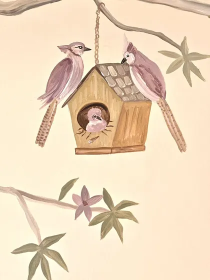 A sweet family of birds in their birdhouse, another detail from the whimsical woodland mural. These small touches are what make a room feel truly special and personal.