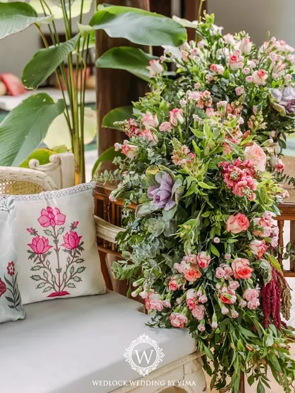 A closer look at the carnival-themed Mehendi decor. We used custom-printed cushions, lush floral cascades, and colorful pinwheels to create a festive and whimsical atmosphere.
