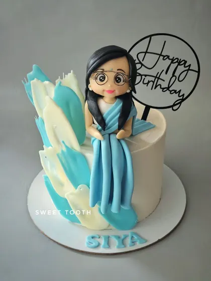 Hey, Chashmish! A cute cake featuring a girl in glasses and a beautiful blue saree. This chocolate truffle cake has modern, artistic buttercream strokes.
