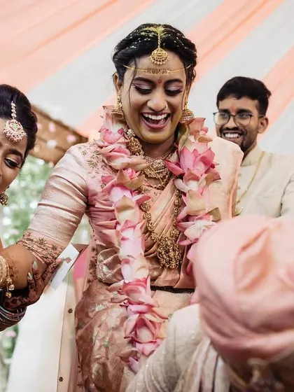 A moment of fun and games during the wedding ceremony. The bride's exuberant laugh shows the joyful and lighthearted side of traditional celebrations.
