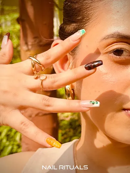 Step out with a whole vibe. This shot highlights a playful and colorful summer manicure, perfect for the season.