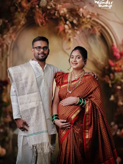 A beautiful portrait from a traditional maternity shoot, featuring the couple in classic Indian attire. We honor cultural traditions to create meaningful family heirlooms.