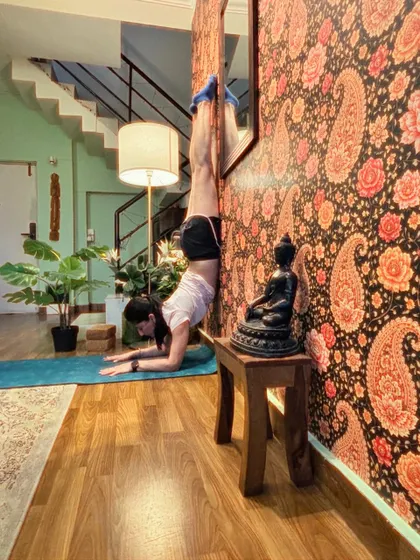 Handstand at the paisley wall again, this time with the hips lower for control.
