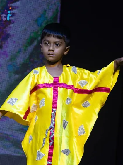 A child in a colorful bird costume represents the creatures that fly on the wind. Our costumes are creative and integral to the storytelling.