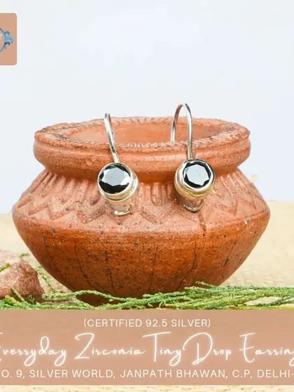 These tiny drop earrings feature a single black zirconia stone, offering a minimalist and chic look for everyday wear.