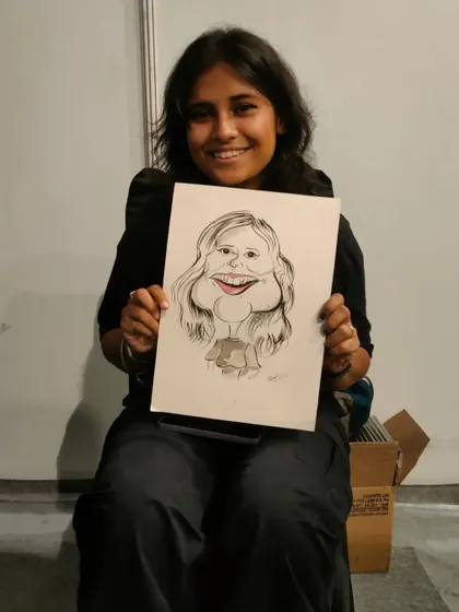 A smiling guest at a Redbull event, happy with her fun and quirky caricature.
