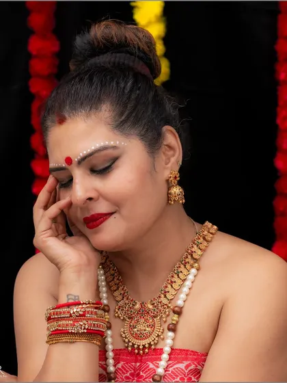 A close-up portrait capturing the serene and divine mood of the Onam festival, styled with traditional makeup and jewelry.