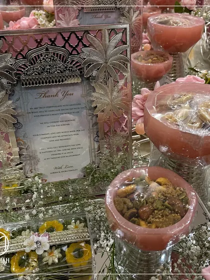 A closer view of the pastel pink thank you hamper, focusing on the personalized note in the silver frame and the beautifully arranged sweets and dry fruits. It's a small gesture that makes a big impact.