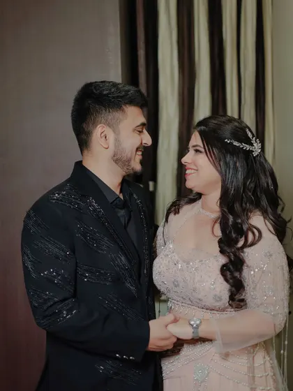 A candid moment of connection between the engaged couple. Their shared smile and gentle hold tell a story of a love that is comfortable, real, and full of happiness.