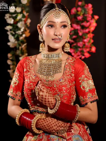 This bride is ready for her big day in a vibrant red lehenga. I created a glowing, dewy makeup look with defined eyes and a neutral lip to complement her modern jewelry and ensure she shines.
