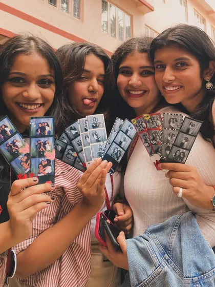 The pure joy of getting your photo strips! We love seeing groups of friends huddle together, laughing at the silly poses and fun moments they just captured. These instant prints are the perfect party favor that everyone gets to take home.