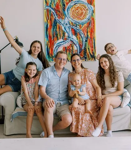 A fun and energetic portrait of a large family on their sofa. I love capturing the unique personality of each family.