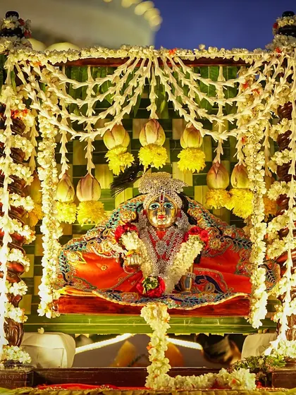 The beautifully decorated idol of baby Krishna in a cradle. On Janmashtami, we celebrate his birth with elaborate decorations, offerings, and devotional songs.