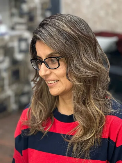 The client looking happy and stylish with her new blonde hair.