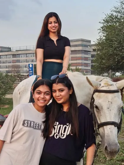 Friends gather for a photo with one of our beautiful white horses. It's all about creating good vibes and lasting memories.